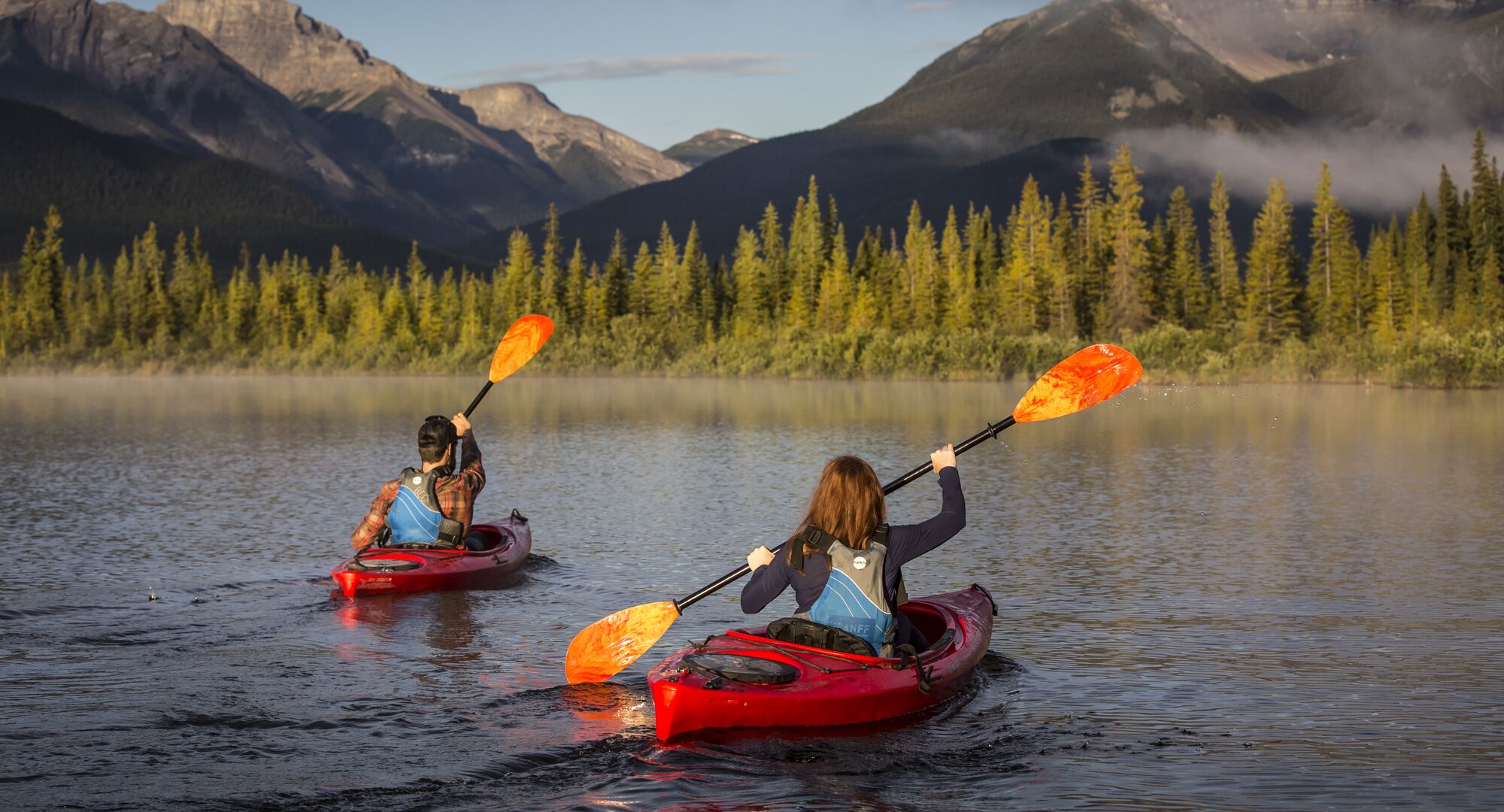 Two people kayaking on Vermilion Lakes in Banff National Park